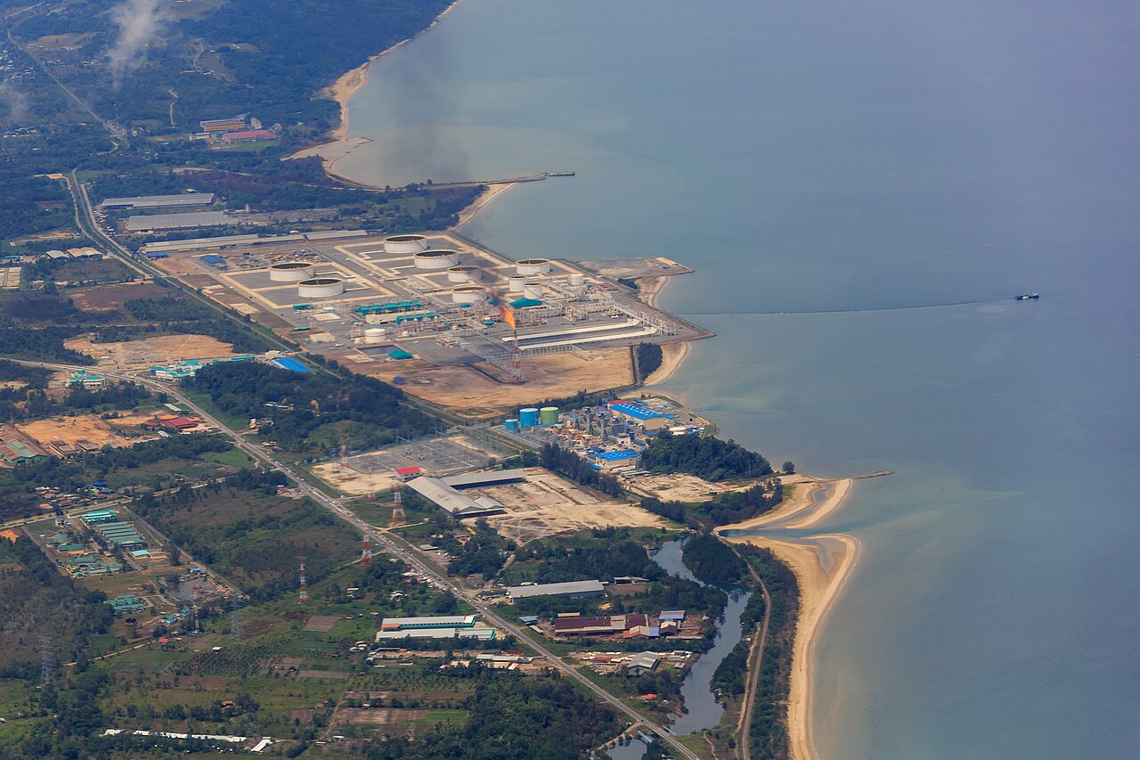 Aerial view of the Sabah Oil and Gas Terminal at Kimanis with storage tanks and gas flare on the coastline.